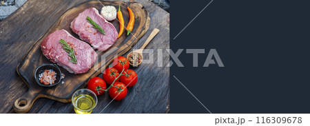 Banner Raw meat beef steak organic fresh ingredient on wooden board table background in kitchen with rosemary, salt, garlic, tomato, olive oil. Meat beef on wooden plate for beefsteak with copy space 116309678