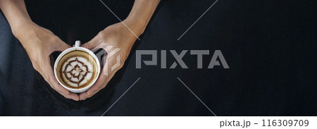 Banner Coffee barista pour espresso shot and make latte art hot coffee cup. Cappuccino with milk in italian coffee shop cafe. Banner Close up hands of barista make brown latte art with copy space 116309709