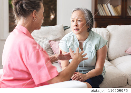 Diverse senior female friends having serious conversation about emotions Diverse senior female friends having serious conversation about emotions 116309976