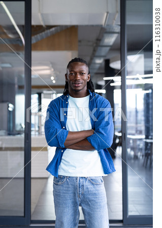 African American man standing confidently with arms crossed in business 116310038