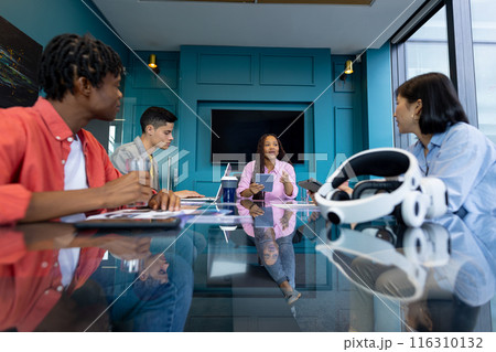 Business team gather in a modern, diverse conference room to collaborate on a startup 116310132