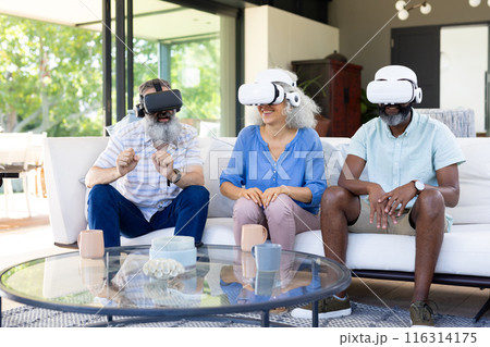 At home, Diverse group of friends using VR headsets, enjoying virtual reality experience 116314175