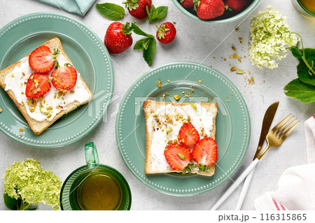 Sweet Toast with strawberry, cottage cheese and pistachios . Sandwich, Bruschetta, snack, appetizers with strawberry. top view 116315865