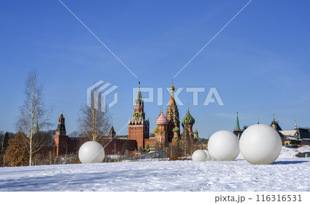 White balls in the snow with the towers of the medieval Kremlin on the horizon in Moscow, Russia 116316531