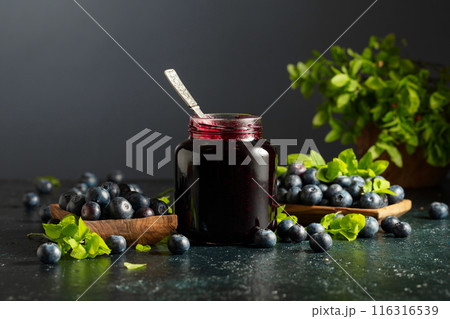 Blueberry jam and fresh berries with leaves. 116316539