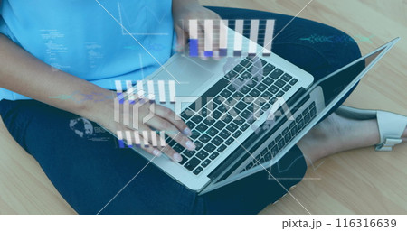 Image of graphs, globe, computer language over biracial woman working over laptop at home 116316639