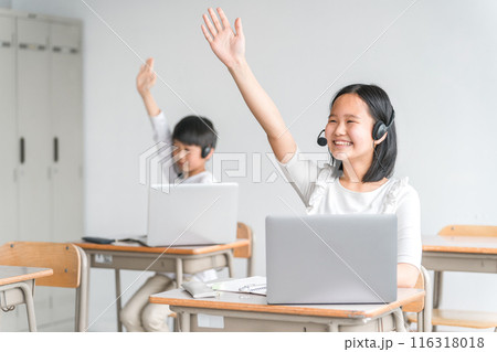 学校の教室・塾でパソコンを使った授業を受け挙手する女子小学生（意見・勉強） 116318018