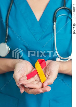 World hepatitis day awareness month, 28 July. Doctor holding Red and Yellow ribbon. Liver cancer, Jaundice, Cirrhosis, Failure, Enlarged, Hepatic Encephalopathy and Health concept 116318054