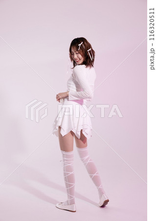 A Korean woman in her 20s wearing a white ballet core look with a light pink background A Korean woman in her 20s wearing a white ballet core look with a light pink background 116320511