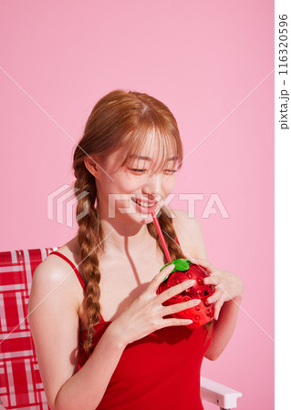 A Korean woman in her 20s wearing a monokini look and holding a drink 116320596