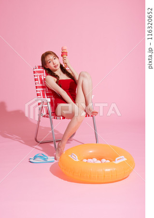 Korean woman in her 20s posing in a chair wearing a monokini look Korean woman in her 20s posing in a chair wearing a monokini look 116320652