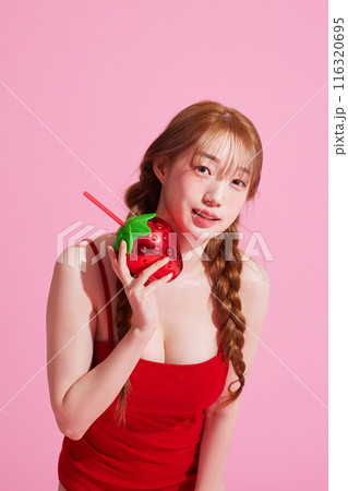 Korean Woman in Her 20s Poses With Strawberry-Shaped Beverage 116320695