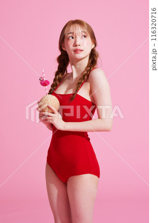 Korean Woman in Her 20s Poses With Coconut Drinks in Monokini Look 116320716
