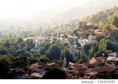 Sunlight illuminating houses of a village nestled in the troodos mountains of cyprus 116324395