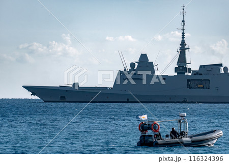 Offshore patrol vessel of Cyprus Navy in Akrotiri Bay with coast guard inflatable boat approaching. Cyprus Offshore patrol vessel of Cyprus Navy in Akrotiri Bay with coast guard inflatable boat approaching. Cyprus 116324396