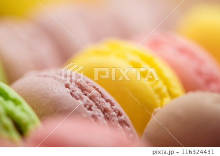 Colorful french macarons forming a delicious background 116324431