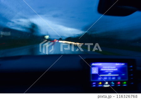 light of car on road in the night, blurred background with rain 116326768