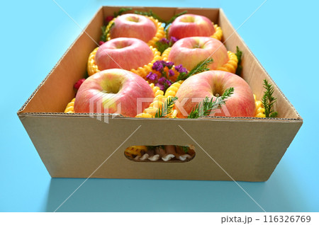 beautiful pink apple in the box on blue background 116326769