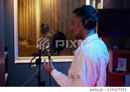 Man Recording His Song In Studio 116327352
