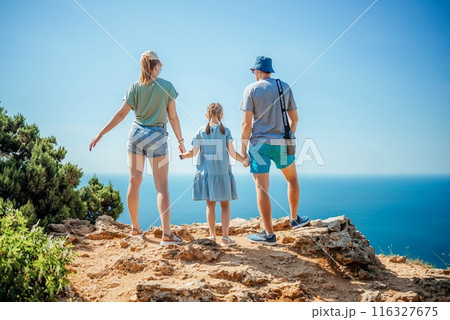 A family of three, a man, a woman and a child 116327675