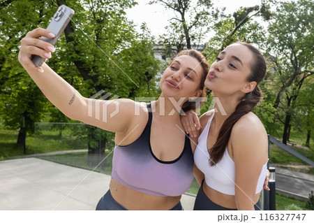 Athletic attractive women in sportswear making selfie during running workout Athletic attractive women in sportswear making selfie during running workout 116327747
