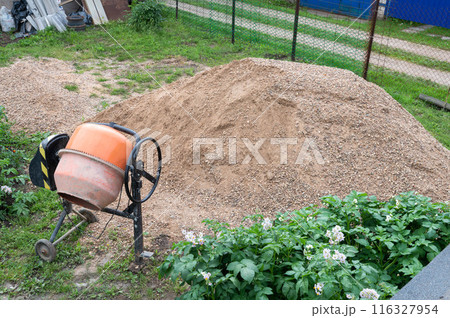 Construction Sand Heap and Cement Mixer at Worksite 116327954
