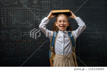 Kid in class on background of blackboard 116328983