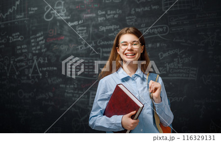 Teenager in class on background of blackboard Teenager in class on background of blackboard 116329131
