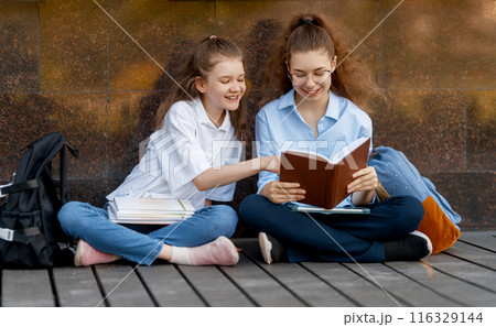 Girls with backpacks outdoors 116329144