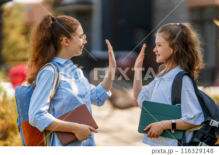 Girls with backpacks outdoors 116329148