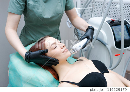 The woman is wearing gloves and a black bra 116329179