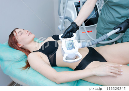 A woman is getting a body contouring treatment A woman is getting a body contouring treatment 116329245