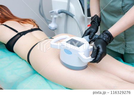 A woman is getting a body contouring treatment A woman is getting a body contouring treatment 116329276