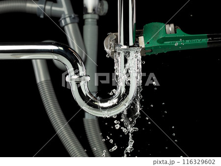 Heavy Duty Wrench fix Water leak under sink. Drain sink leak water from many pipe hose plumbing in bathroom and repair by wrench tools as water splash drop. Black background isolated Heavy Duty Wrench fix Water leak under sink. Drain sink leak water from many pipe hose plumbing in bathroom and repair by wrench tools as water splash drop. Black background isolated 116329602