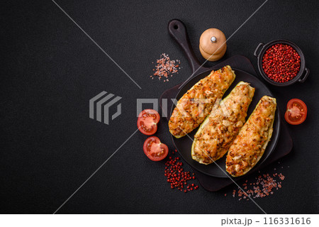 Zucchini halves baked with cheese, tomatoes, meat or meat substitute Zucchini halves baked with cheese, tomatoes, meat or meat substitute 116331616
