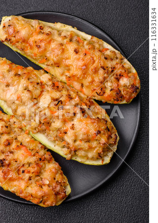Zucchini halves baked with cheese, tomatoes, meat or meat substitute Zucchini halves baked with cheese, tomatoes, meat or meat substitute 116331634