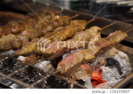 Grilled lamb skewers grilled over charcoal fire Grilled lamb skewers grilled over charcoal fire 116335607