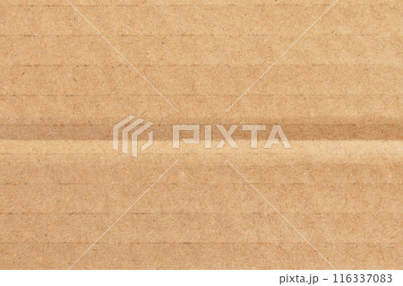 Corrugated cardboard box brown surface with fold lines. Recycled paper sheet texture background 116337083