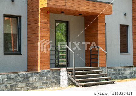 Modern House Exterior Featuring Glass Door, Steps, and Porch with Elegant Design Elements 116337411