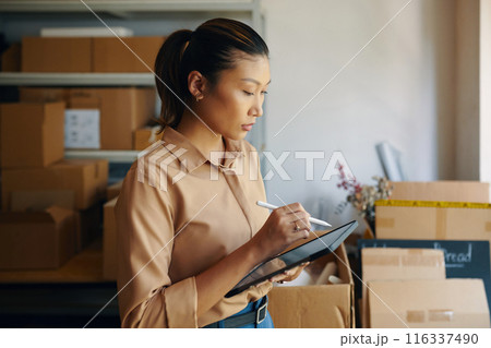 Woman Using Tablet PC In Warehouse 116337490