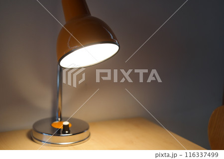 Close up of a modern desk lamp in the dark room Close up of a modern desk lamp in the dark room 116337499