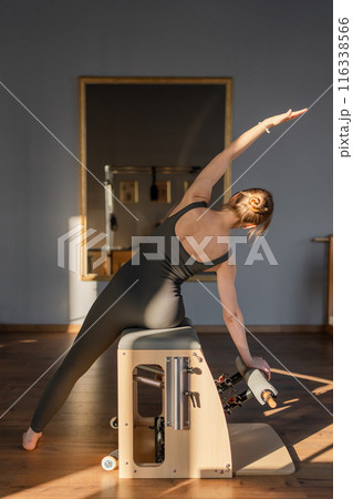 Woman doing mermaid exercise in a sunlite modern studio, embodying calm, focus, and strength. Woman doing mermaid exercise in a sunlite modern studio, embodying calm, focus, and strength. 116338566