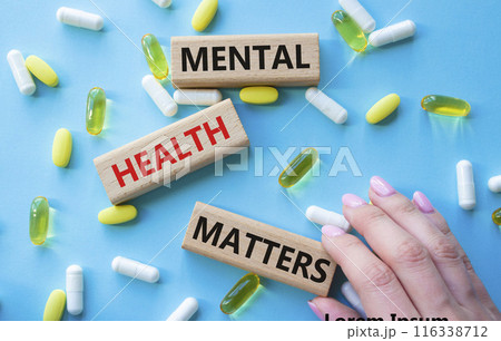 Mental Health Matters symbol. Concept words Mental Health Matters on wooden blocks. Beautiful blue background with pills. Doctor hand. Healthcare and Mental Health Matters concept. Copy space. Mental Health Matters symbol. Concept words Mental Health Matters on wooden blocks. Beautiful blue background with pills. Doctor hand. Healthcare and Mental Health Matters concept. Copy space. 116338712