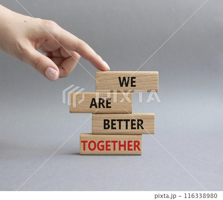 We are better together symbol. Wooden blocks with words We are better together. Beautiful grey background. Businessman hand. We are better together concept. Copy space. 116338980