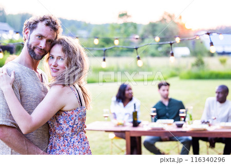 Enjoy a summer party with friends in a cozy backyard filled with warmth, laughter, and joy Enjoy a summer party with friends in a cozy backyard filled with warmth, laughter, and joy 116340296