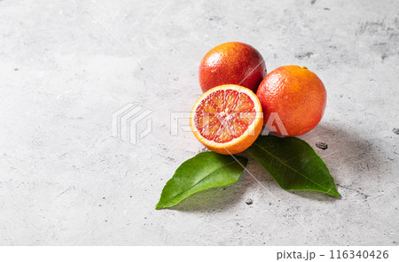 Juicy sicilian red oranges on a gray concrete background. Top view and copy space Juicy sicilian red oranges on a gray concrete background. Top view and copy space 116340426