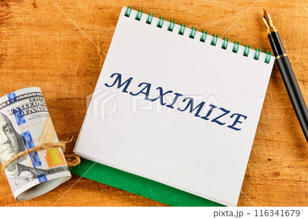 MAXIMIZE text on a blank sheet of notepad against a papyrus background 116341679