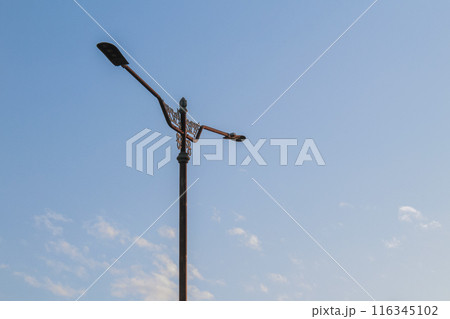 street lights against blue sky in the morning 116345102