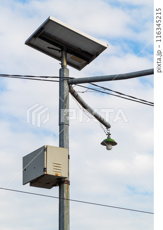 metal pole with common lights and cables with sky background 116345215