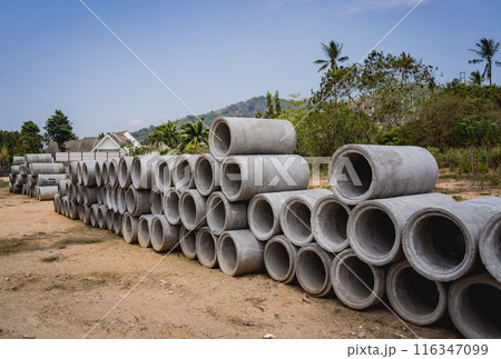 A stack of concrete ring pipes piled and creating a symmetrical arrangement A stack of concrete ring pipes piled and creating a symmetrical arrangement 116347099